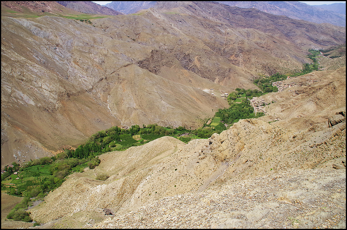This is the valley into which they are looking. An oasis valley just below the Tizi n'Tichka Pass in the Atlas Mountains of Morocco. This entire valley is green from the stream in the photo above.
