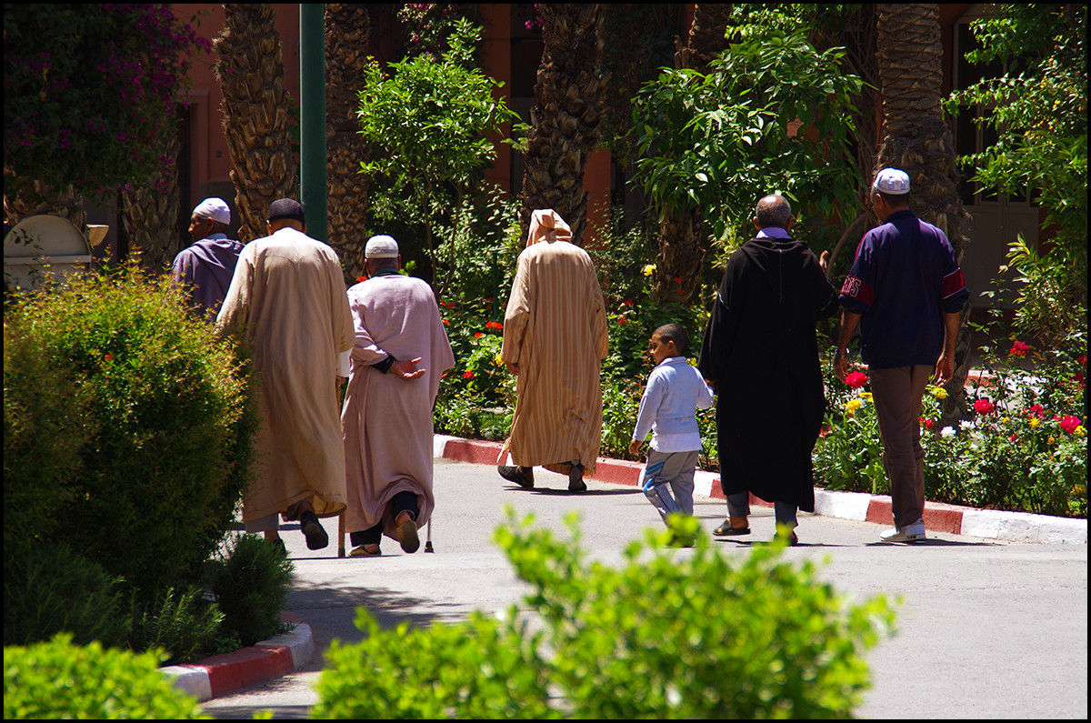 Men leaving a mosk after prayer time in Marrakesh, Morocco.