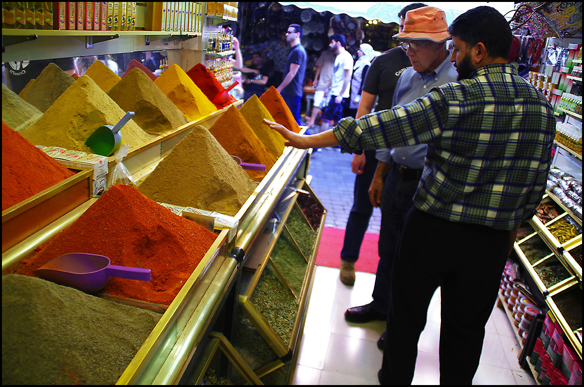 A spice vendor in the Marrakesh Medina. My dad and brother looking on. I don't think we ended up buying anything from him.